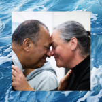 A man and woman share a hongi, a traditional Māori greeting, symbolising connection, respect, and unity.