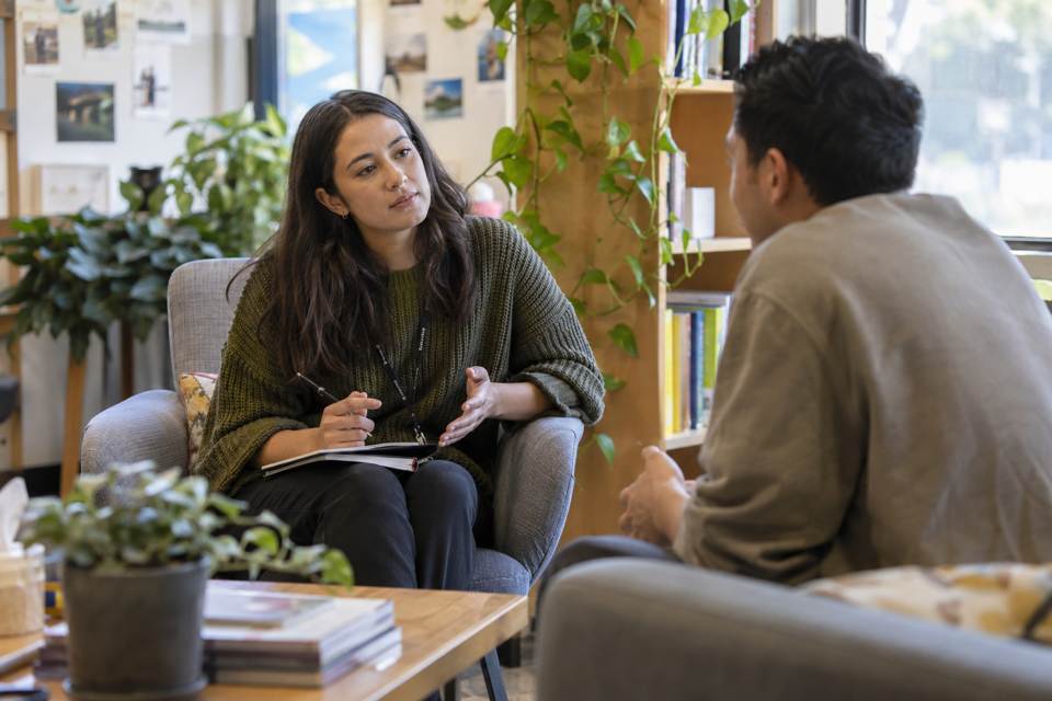 Two adults in a counselling-style conversation